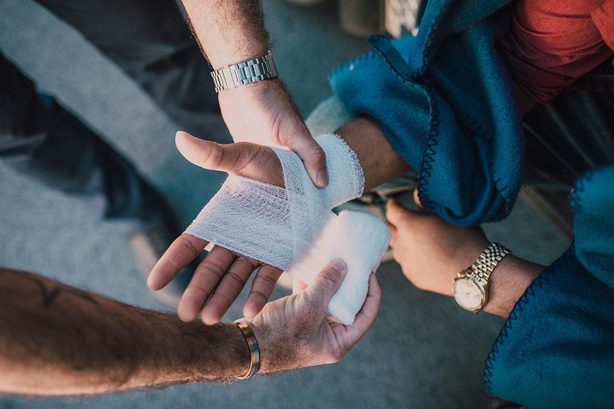 Close up of patient getting hand wrapped by bandages